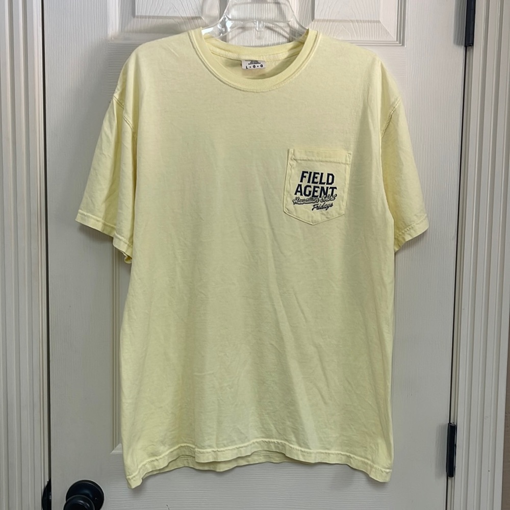 Size large yellow tshirt. Logo says Field Agent Hawaiian shirt.